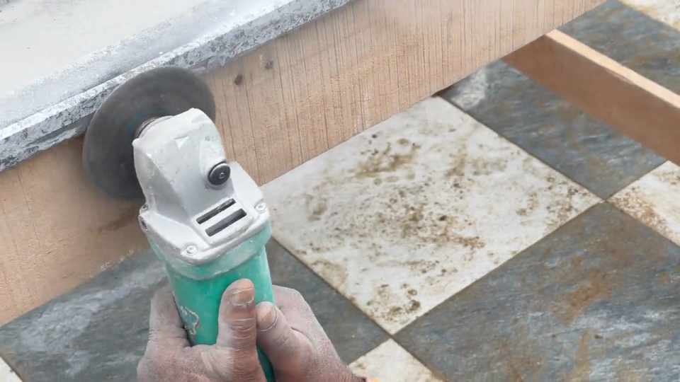 Craftsman grinding and finishing the edge of a stone slab